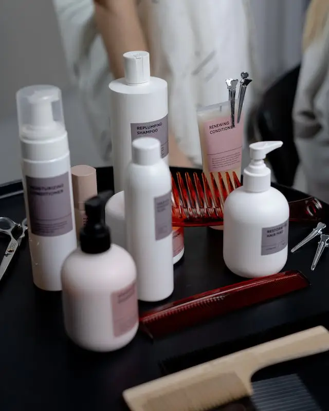 Professional shampoo and conditioner bottles on a salon shelf